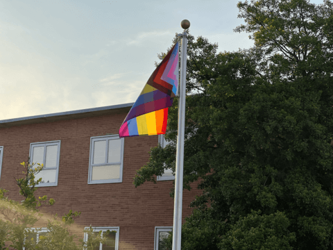 LGBTQ flag flying on Howard University's campus.